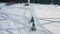 Close-up of two guys going on a snowmobiles on a snowy track near the coniferous trees. Footage. Winter racing