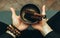 Close-up two hands of a man holding singing bowls with sticks in front of him. Listen to the healing vibrations of Tibetan bowls.