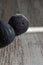 Close-up of two illuminated purple figs on wooden background