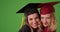 Close-up of two intelligent college girls celebrating graduation on greenscreen