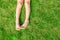 Close-up of two legs of a young girl on the grass