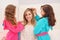 Close up of two litle girls playing with the hair of their mom, while curly girls is wearing a pink bathrope and