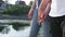 Close up of two lovers joining hands. Detail silhouette of man and woman holding hands and standing near the pond