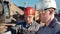 Close-up two male construction engineer wearing helmet and glasses discussing working