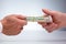 Close-up Of Two Male Hand`s Holding Currency Bundle