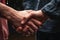 Close-up of Two men holding hands in the rain