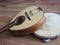 Close-up of two musical instruments: Portuguese mandolin and pandeiro tambourine.