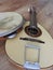 Close-up of two musical instruments: Portuguese mandolin and pandeiro tambourine.