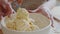 Close-up two pairs of female hands caucasian unrecognizable mother woman and little girl child cooking together in