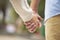 Close-up of two people in love holding hands outdoor showing romance