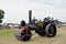 A close up of two people on a traction engine