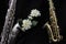 Close up of two saxophones decorated with flowers