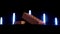 Close up of two solid bricks of red color placed in front of neon shining lamps on black background. Stock footage