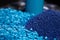 Close up of a two stacks of blue plastic polypropylene granules on a table,Generative AI