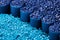 Close up of a two stacks of blue plastic polypropylene granules on a table,Generative AI