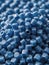 Close Up Of A Two Stacks Of Blue Plastic Polypropylene Granules On A Table. Generative AI