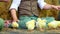 Close-up. Two village, stylishly dressed boys play with ducklings and chickens, in the background a haystack.