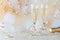 A close up of two wine flutes filled with champagne ready for a celebration.