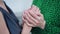 Close-up two women holding hands caressing palms supporting each other. Caucasian friends outdoors endorsing encouraging