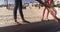 Close up of two womens feet standing on wall at beach