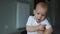 Close-up, a two-year-old baby raises an orange from the floor. Children and vegetarianism, healthy eating