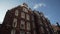 Close-up of typical English red brick houses against the blue sky in sunny day. Action. Traditional English architecture