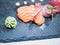 Close-up of a typical Japanese dish of sushimi with tuna salmon roll on a black background