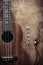 Close up of ukulele and earphone on old wood background