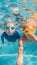 Close-up underwater portrait of the two cute smiling kids VERTICAL FORMAT for Instagram mobile story or stories size