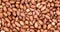Close up of unpeeled peanuts. Food background