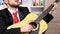 Close up unrecognisable businessman in black suit and red tie plays at acoustic guitar