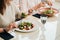 Close Up of Unrecognisable Women Having Lunch Meeting, Eating Salad in the Restaurant