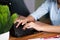 Close up of unrecognisable young business woman working or typing on laptop keyboard at table in office