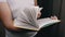 Close up, Unrecognizable Boy Flipping through Pages of a Book