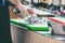 Close up of unrecognizable cook cutting onions and other vegetables with chef knife while working