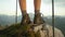 CLOSE UP: Unrecognizable hiker girl wearing leather boots observes the valley.