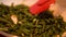 Close-up of unrecognizable person mixing asparagus on frying pan. Unknown human cooking healthful food in kitchen at