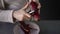 Close-up. An unrecognizable pregnant woman peels red beetroot with a vegetable peeler while standing at the table in her