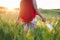 Close up of unrecognizable woman walking outdoors throwing away her mask. Young happy girl removing protective mask. End