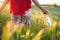 Close up of unrecognizable woman walking outdoors throwing away her mask. Young happy girl removing protective mask. End