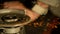 CLOSE UP: Unrecognizable worker steel grinding a workpiece in his dark workshop.