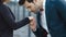 Close up unrecognized couple standing at street. Man kissing hand outdoors