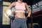 Close up of unrecognized young athlete Asian girl in sportswear standing with six packs abs abdominal in gym or fitness club after