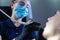 Close-up, from an unusual angle, view, a dentist using dental equipment treats a patient a girl with a tooth and oral cavity