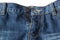 Close-up of unzipped and unbuttoned blue jeans