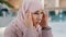 Close-up upset young woman gets bad news feels stressful anxiety frustrated muslim girl suffers from headache grabs head