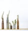 Close Up Used Bullet Shell Vases with Plants on White Background