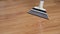 Close-up of a vacuum cleaner cleaning up spilled wine on the floor. Cleaning
