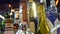 Close-up of variety of alcohol in bar. Frame. Colorful glass bottles stand on bar counter on background of bright lamps