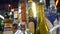 Close-up of variety of alcohol in bar. Frame. Colorful glass bottles stand on bar counter on background of bright lamps